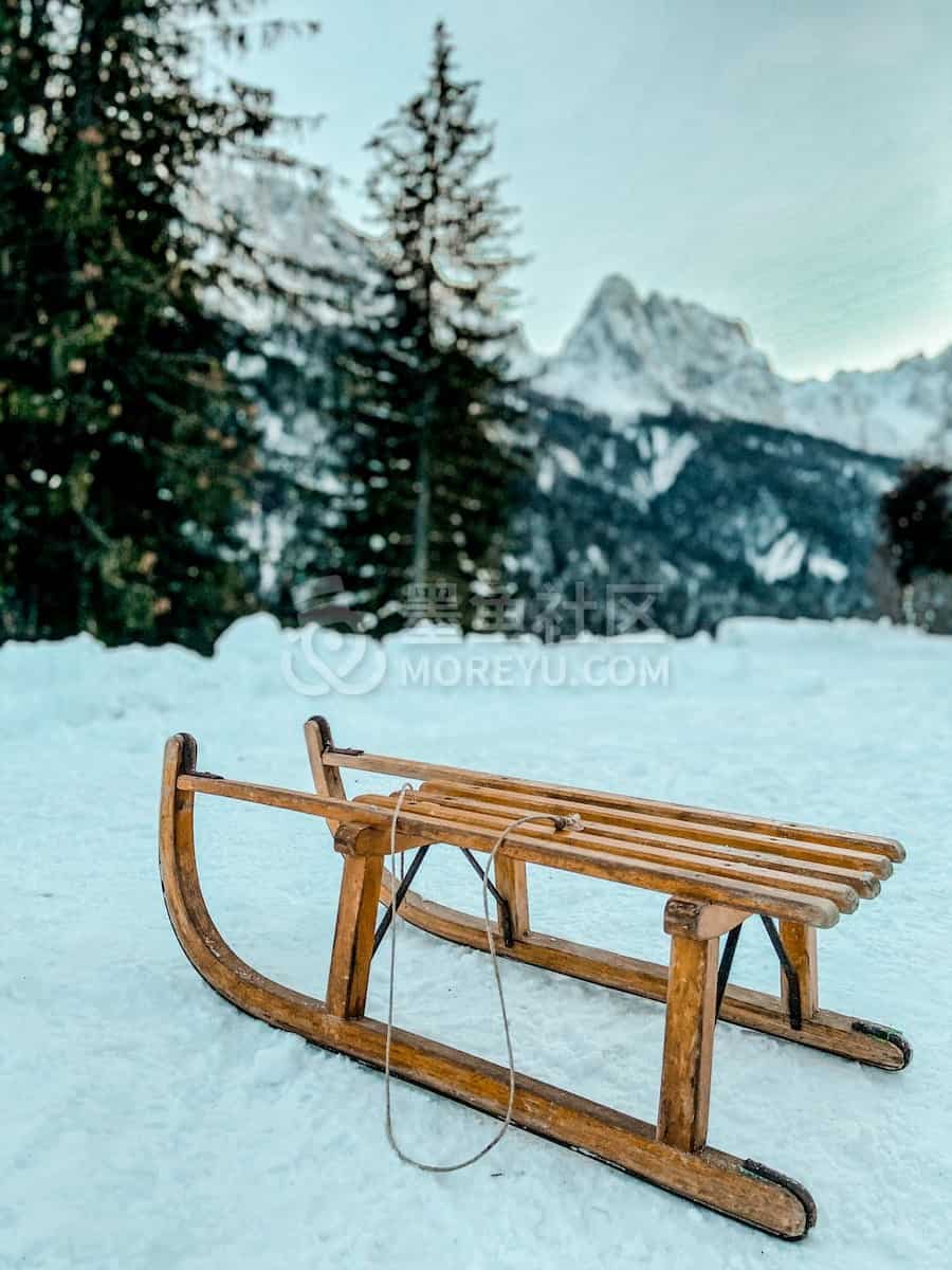 brown wooden picnic table on snow covered ground during daytime